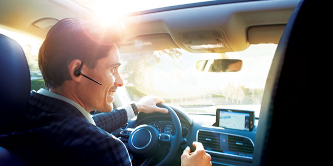 Poly Voyager 5200 UC Being Worn by Man in Car