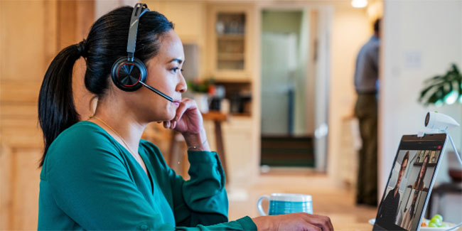 Woman in Home Office Wearing Poly Voyager Focus 2 Headset