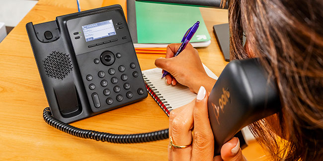 Woman Using Poly Edge B30 IP Phone