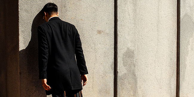 Man with Head Against Wall