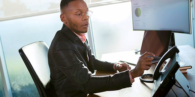 Poly CCX 600 Used By Man At Desk