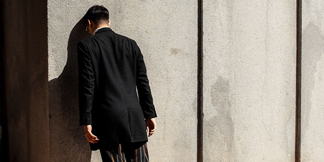 Man with Head Against Wall